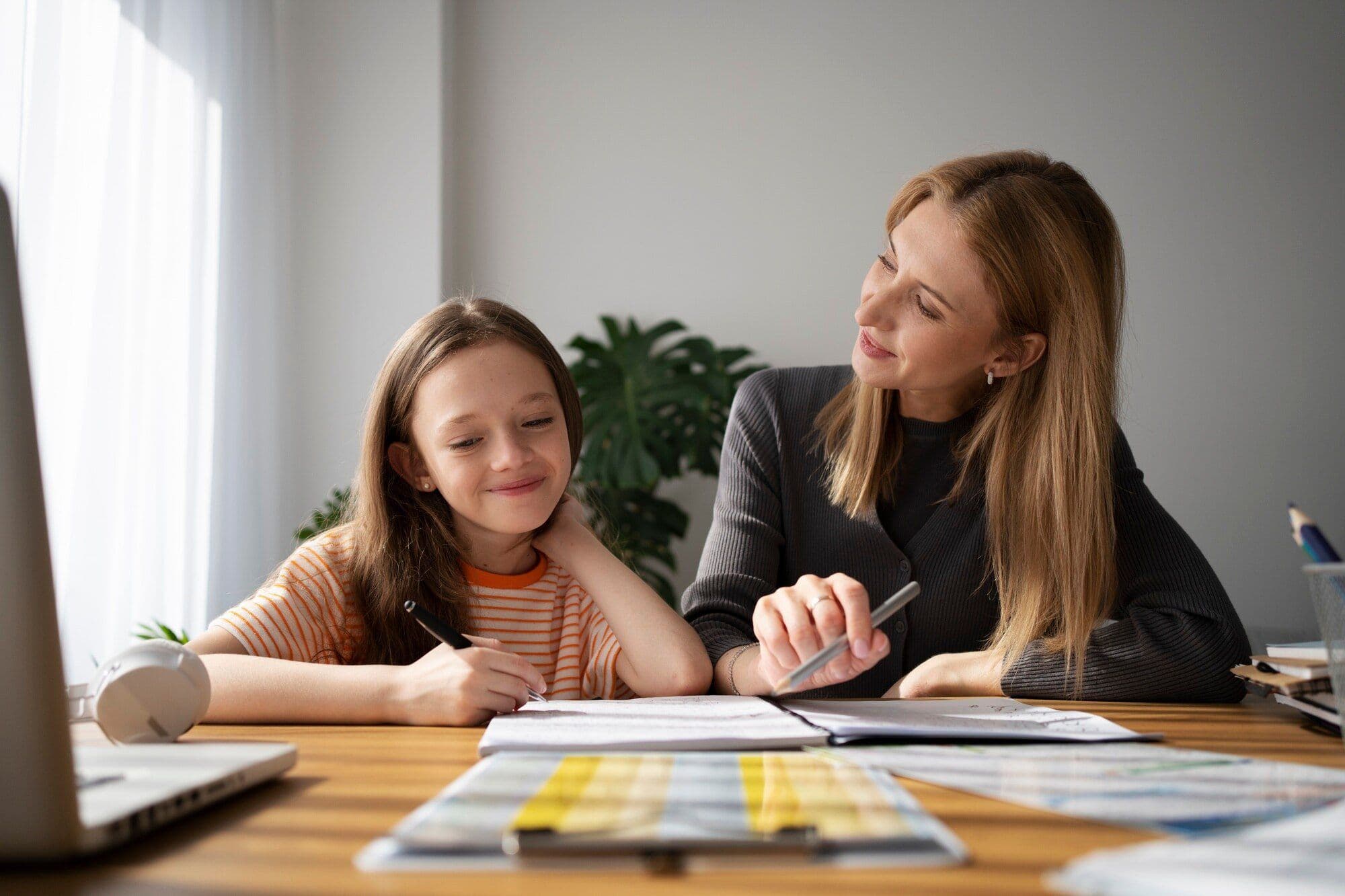 teacher-helping-girl-learning-english_52683-86638